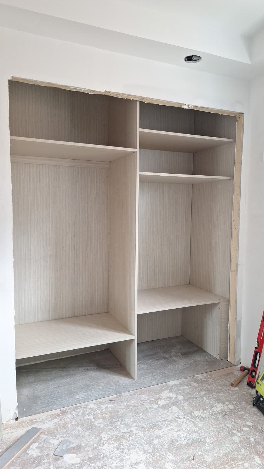 Light wood-look closet interior with shelves during installation