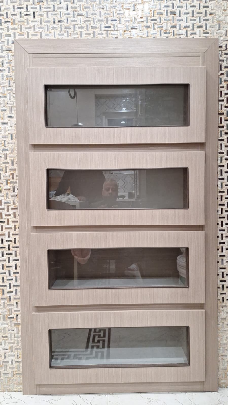 Recessed four-section glass-front display cabinet with light wood-look surround